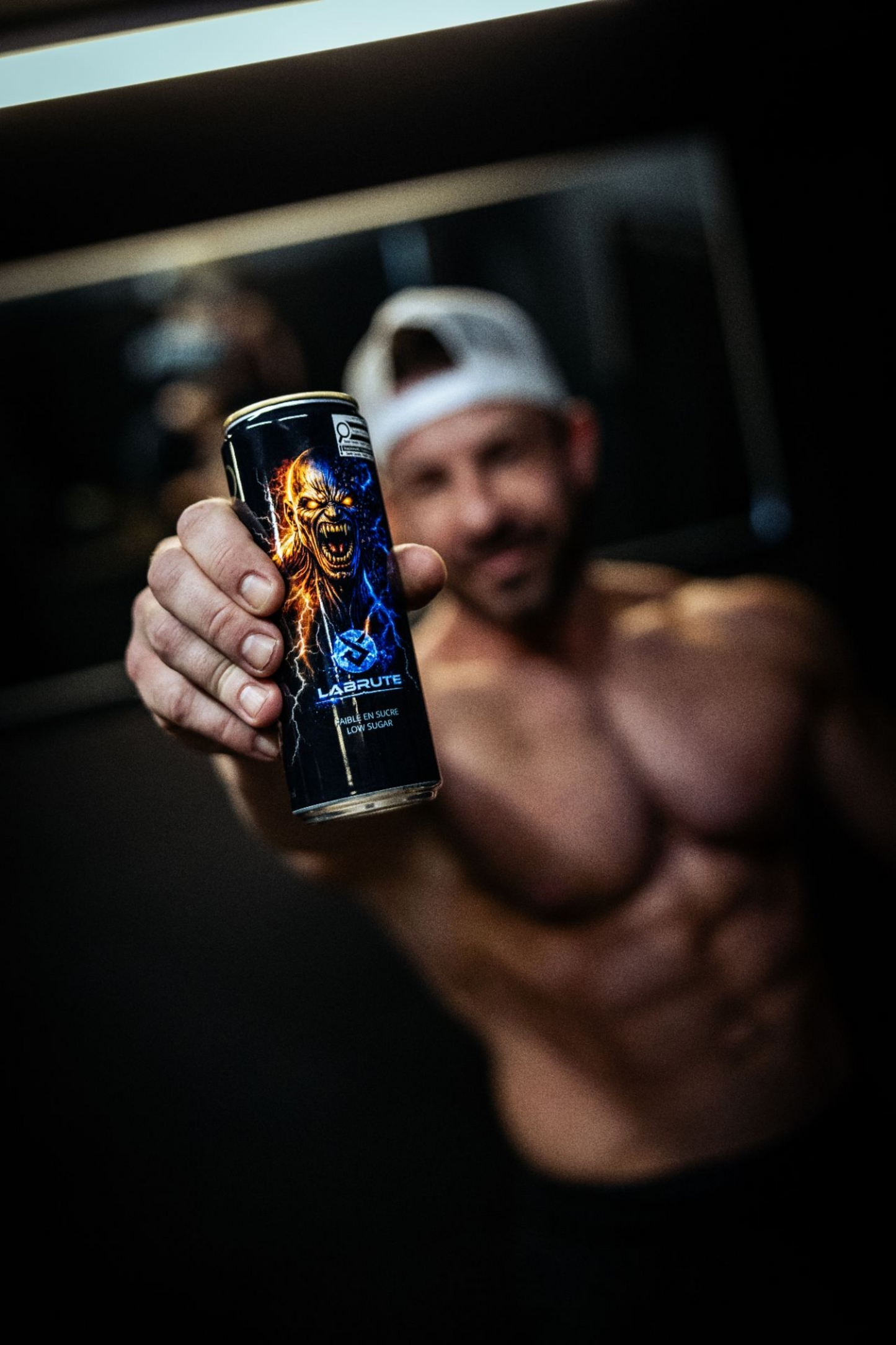 Labrute X OnOff Energy Drink low sugar 355 ml can made in Canada held by an athlete in a gym