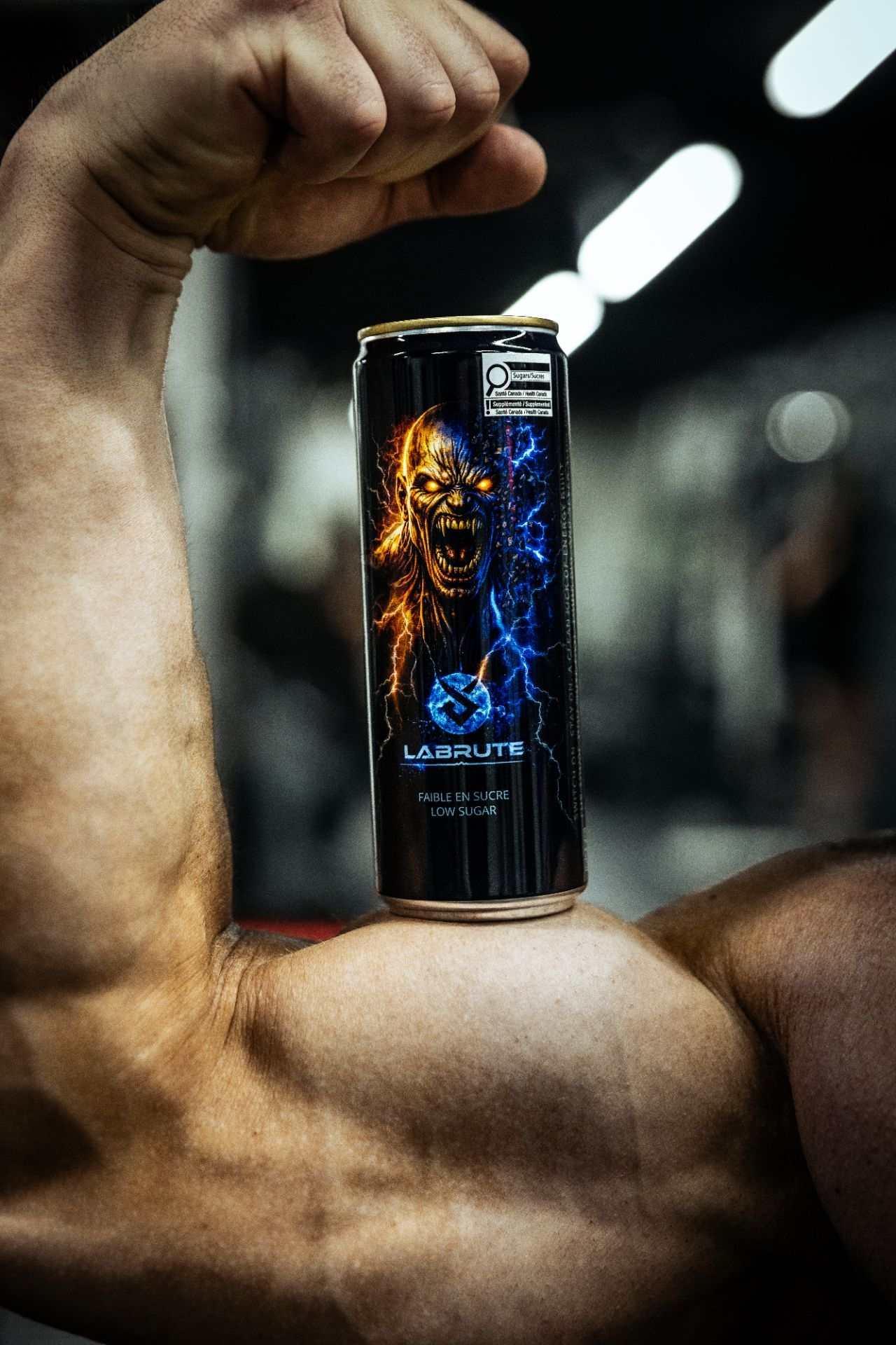 Labrute X OnOff Energy Drink low sugar can on an athlete bicep in a gym